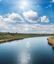 River and sun in clouds over it Royalty Free Stock Photo