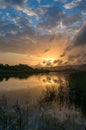 River sunset landscape with beautiful clouds and water reflection Royalty Free Stock Photo