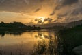 River sunset landscape with beautiful clouds, water reflection Royalty Free Stock Photo