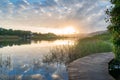 River sunset landscape with beautiful clouds and water reflection Royalty Free Stock Photo