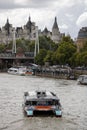 River Thames and boats with Hungerford Bridge and Royal Horseguards Hotel in the background.