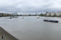 People walk on the exposed shoreline on the River Thames at low water in Greenwich