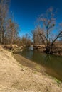 River with trees around and clear sky during early springtime