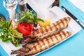 River trout steak, white meat fish, served with vegetables, lemon and arugula and tomato salad Royalty Free Stock Photo