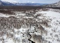 River valley in the mountainous snow-covered wild tundra of the Kamchatka Peninsula