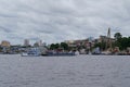 River view of the busy port of Manaus with a lot of ferries and boats. and some skyscrapers visible in the background. Location: