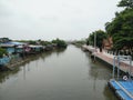 River view in front of Buddhist temple, local residence on waterfront on river Royalty Free Stock Photo