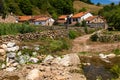 River view, stone fence, white houses, red roofs. Carmona, Cantabria, Spain Royalty Free Stock Photo