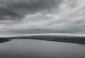 river view stretching far with thick clouds overhead. Royalty Free Stock Photo