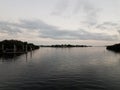 river water with dock and house and clouds Royalty Free Stock Photo