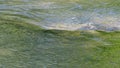 River, water flow along the river. A green background conveys the surrounding forest. Background picture.