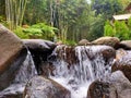 river water flows through the rocks in the forest Royalty Free Stock Photo