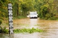 River water level indicator by a flooded lane during Storm Alex. UK