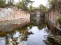 Granite quarry is very old completely flooded vertical walls heading to the water quarry is clean for swimming mining Royalty Free Stock Photo