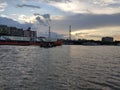 River water ship boat sky clouds sunset buildings