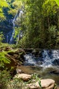 River and waterfall through dense rainforest vegetation