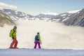 A river of white fog in the mountains and two people in front, snowboarders and skiers are preparing for the descent..Alpine Alps Royalty Free Stock Photo