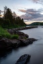 River in the wilderness next to a forest area at dusk in Norrland Royalty Free Stock Photo