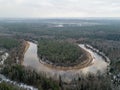 River in winter forest with green trees from above. Aerial drone image of river Gauja in Latvia Royalty Free Stock Photo