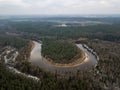 River in winter forest with green trees from above. Aerial drone image of river Gauja in Latvia Royalty Free Stock Photo