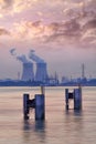 Riverbank with nuclear power plant Doel during a sunset with dramatic cluds, Port of Antwerp Royalty Free Stock Photo