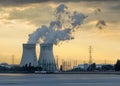 Riverbank with nuclear power plant Doel during a sunset with dramatic cluds, Port of Antwerp