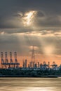 Riverbank with silhouettes of container terminal cranes during a sunset, Port of Antwerp, Belgium