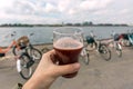 Riverbanks and hand with beer glass. Center of city Copenhagen, Denmark. Danish capital bicycles and fun time