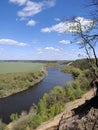 Riverbend in deep spring forestm with green trees on the bank of the river and sands under blue sky Royalty Free Stock Photo