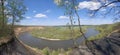 Riverbend in deep spring forestm with green trees on the bank of the river and sands under blue sky Royalty Free Stock Photo