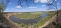 Riverbend in deep spring forestm with green trees on the bank of the river and sands under blue sky Royalty Free Stock Photo