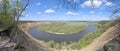 Riverbend in deep spring forestm with green trees on the bank of the river and sands under blue sky Royalty Free Stock Photo