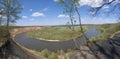 Riverbend in deep spring forestm with green trees on the bank of the river and sands under blue sky Royalty Free Stock Photo