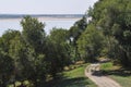 Riverscape with trees and paved path Royalty Free Stock Photo