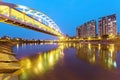 Riverside buildings and the famous HuanDong Rainbow Bridge over Keelung River at dusk in Taipei Taiwan Royalty Free Stock Photo