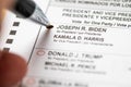 Riverside, California, USA - 10/2020: Man Fills In Joe Biden Voting Bubble with Pen On Official Ballot in the 2020 Presidential