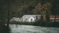 Riverside Charm: Farming Cottage Embraced by Nature\'s Elegance