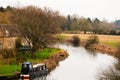 Riverside cottages by the River in the English Countryside with a narrowboat Royalty Free Stock Photo