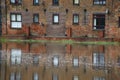 Riverside flats reflected in water at high tide. Royalty Free Stock Photo