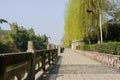 Riverside paved footway with stone balustrades in sunny spring