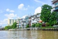 Riverside residential buildings with blue sky background at Chao Phraya river, Bangkok, Thailand