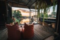 Riverside restaurant seats and tables near Chiang Mai during sunset in Lampang, Thailand.