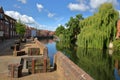 The riverside river Wensum in Norwich Norfolk, UK with colorful houses on the left side and the Fye Bridge in the background Royalty Free Stock Photo