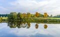 Riverside scene with trees that are reflected in the river Tauber Royalty Free Stock Photo