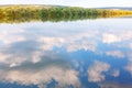 Riverside trees and clouds reflection Royalty Free Stock Photo