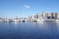 The riverwalk along the Cape Fear River in downtown Wilmington NC, with a marina, houseboats and apartments