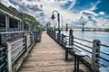 Riverwalk along the waterfront of the Cape Fear River overlooking Memorial Bridge Wilmington, NC Royalty Free Stock Photo