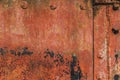 Riveted Corroded Rusty Metal Plates With Cracked Peeled Off Flaky Red Anti-corrosive Paint And Patches Of Tar And Rust Royalty Free Stock Photo