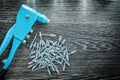 Riveting pliers pile of screws on wooden board Royalty Free Stock Photo