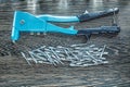 Riveting pliers screws on wooden board Royalty Free Stock Photo